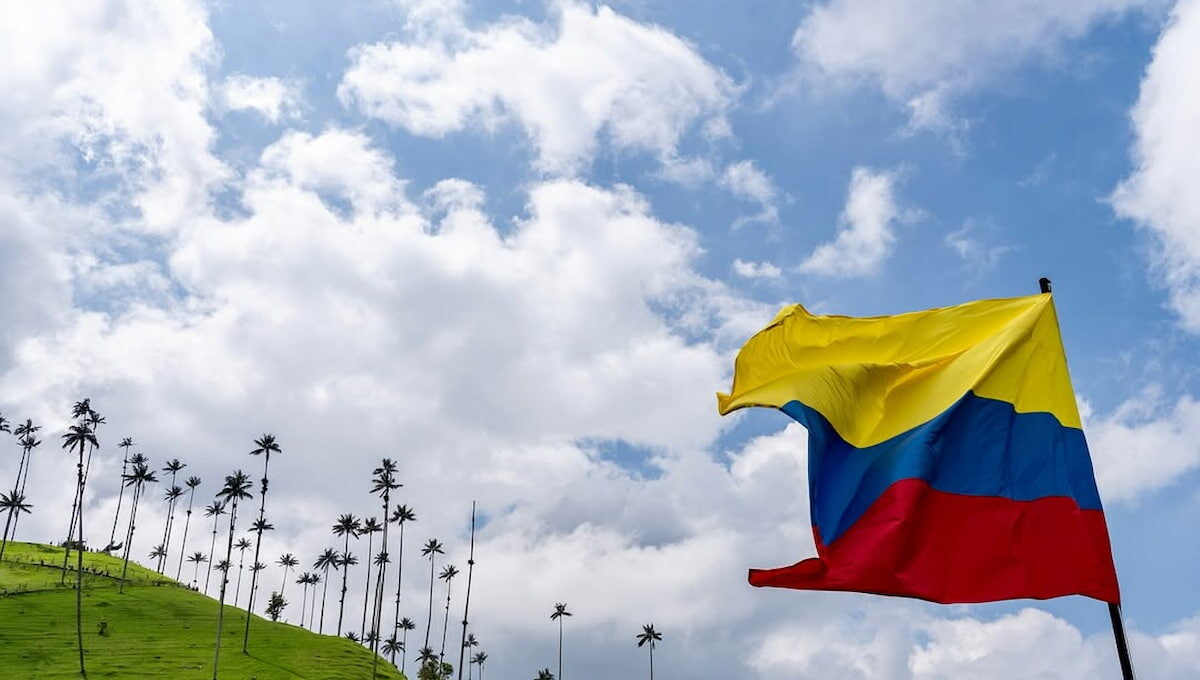 Colombian flag waving over wax palm hills in Cocora Valley, Quindío, Colombia