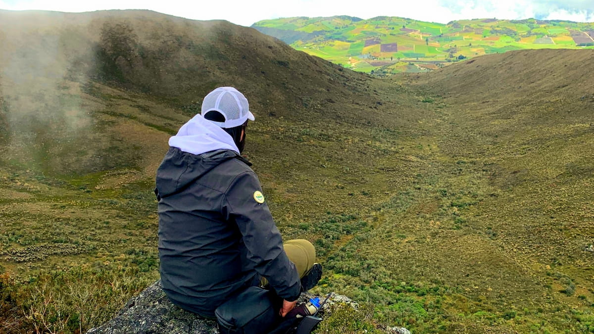 Hiker overlooking a mountain valley in Sumapaz Páramo, Colombia
