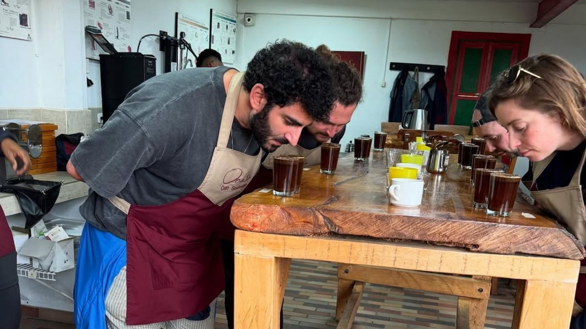 Travelers smelling fresh coffee at a farm near Salento, Quindío, Colombia