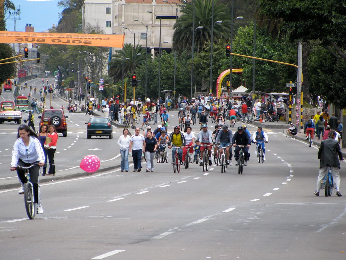 Cyclists and pedestrians enjoying Ciclovía on a city avenue in Bogotá, Colombia