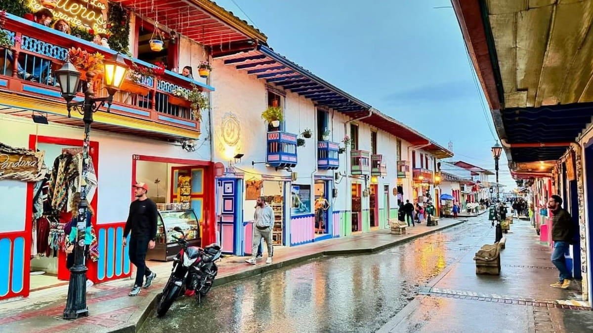People walking along a colorful street in Salento, Quindío, Colombia