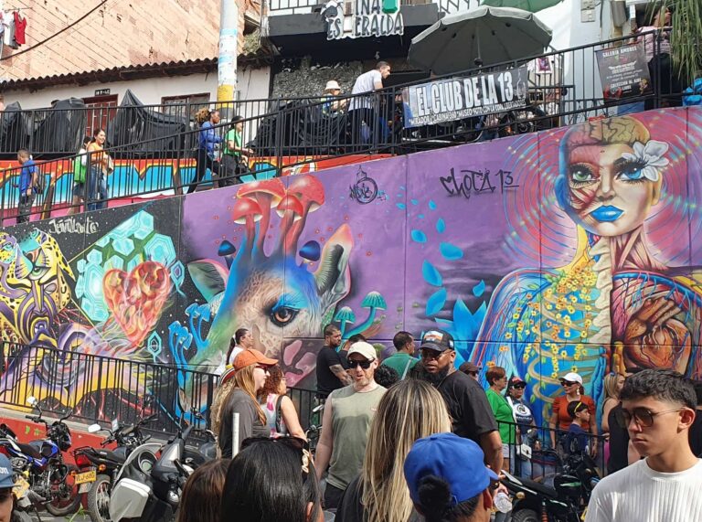 Visitors in front of a mural in Comuna 13, Medellín