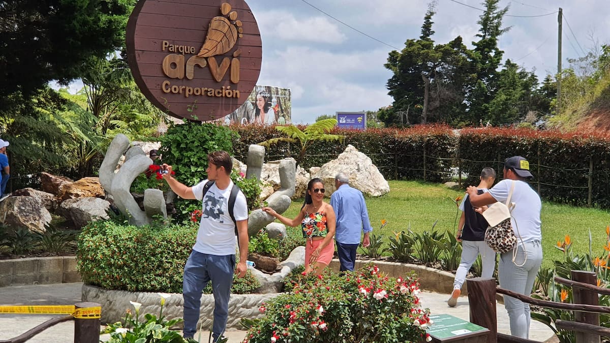 Visitors taking photos at the Parque Arví entrance in Medellín, Colombia