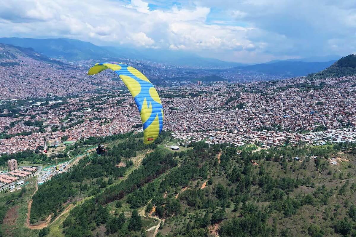Paragliding in Medellín above the city skyline and mountain valley, Colombia