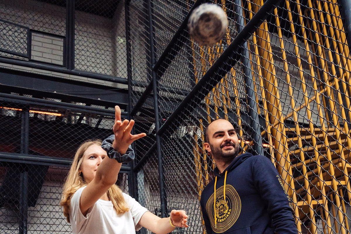Traveler throwing a tejo disc with a guide at La Embajada in Bogotá, Colombia.