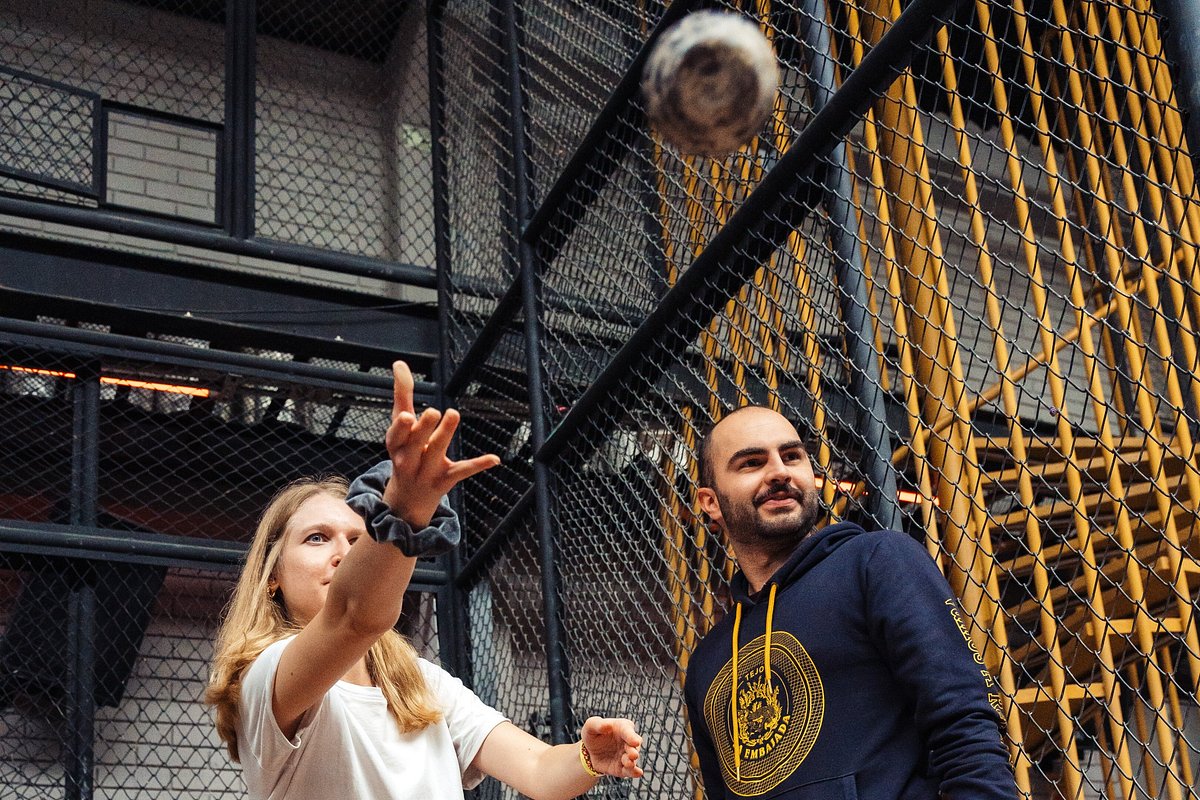 Traveler throwing a tejo disc with a guide at La Embajada in Bogotá, Colombia.