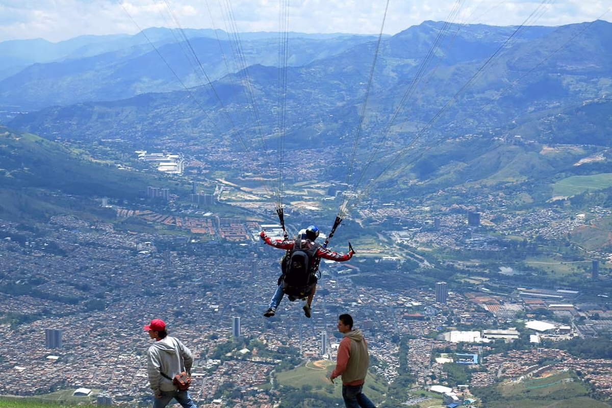 Tandem paragliding in Medellín during takeoff over the Aburrá Valley, Colombia