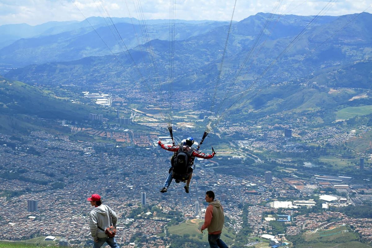 Tandem paragliding in Medellín during takeoff over the Aburrá Valley, Colombia