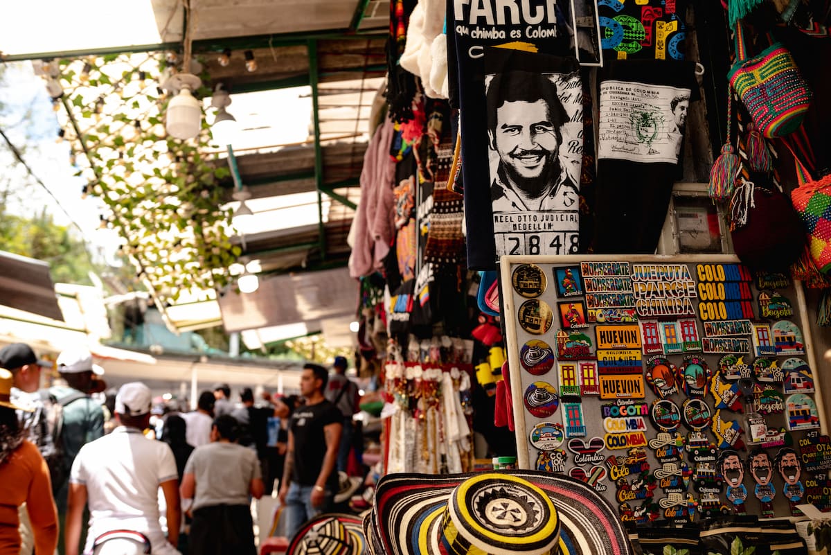 Souvenir stall with Pablo Escobar shirts and magnets in Medellín, Colombia.
