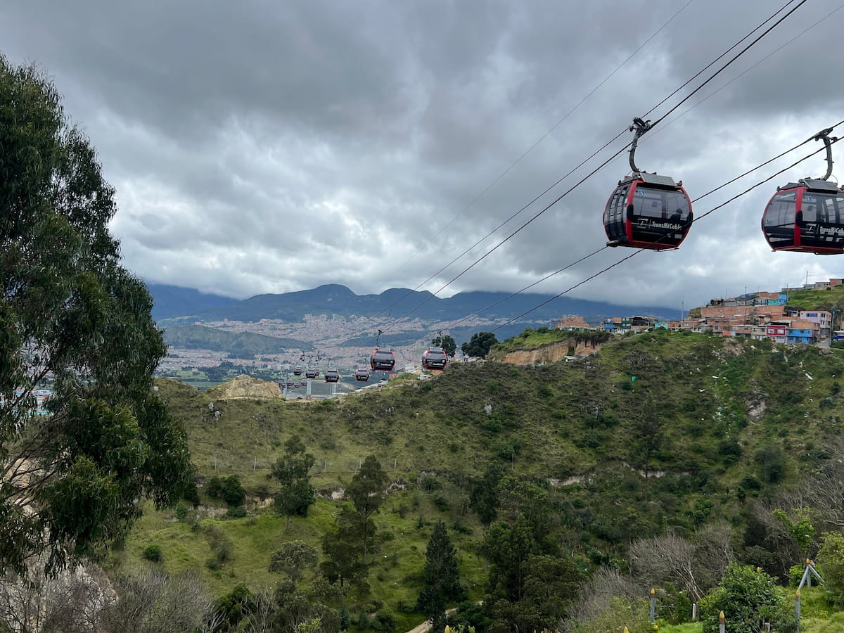 TransMiCable cabins crossing the hills of El Paraíso in Ciudad Bolívar, Bogotá, Colombia.