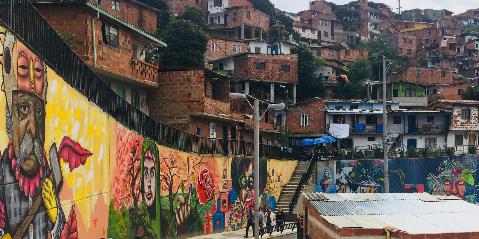 Murals and hillside homes seen on a Graffiti Tour Medellin in Comuna 13, Medellin, Colombia