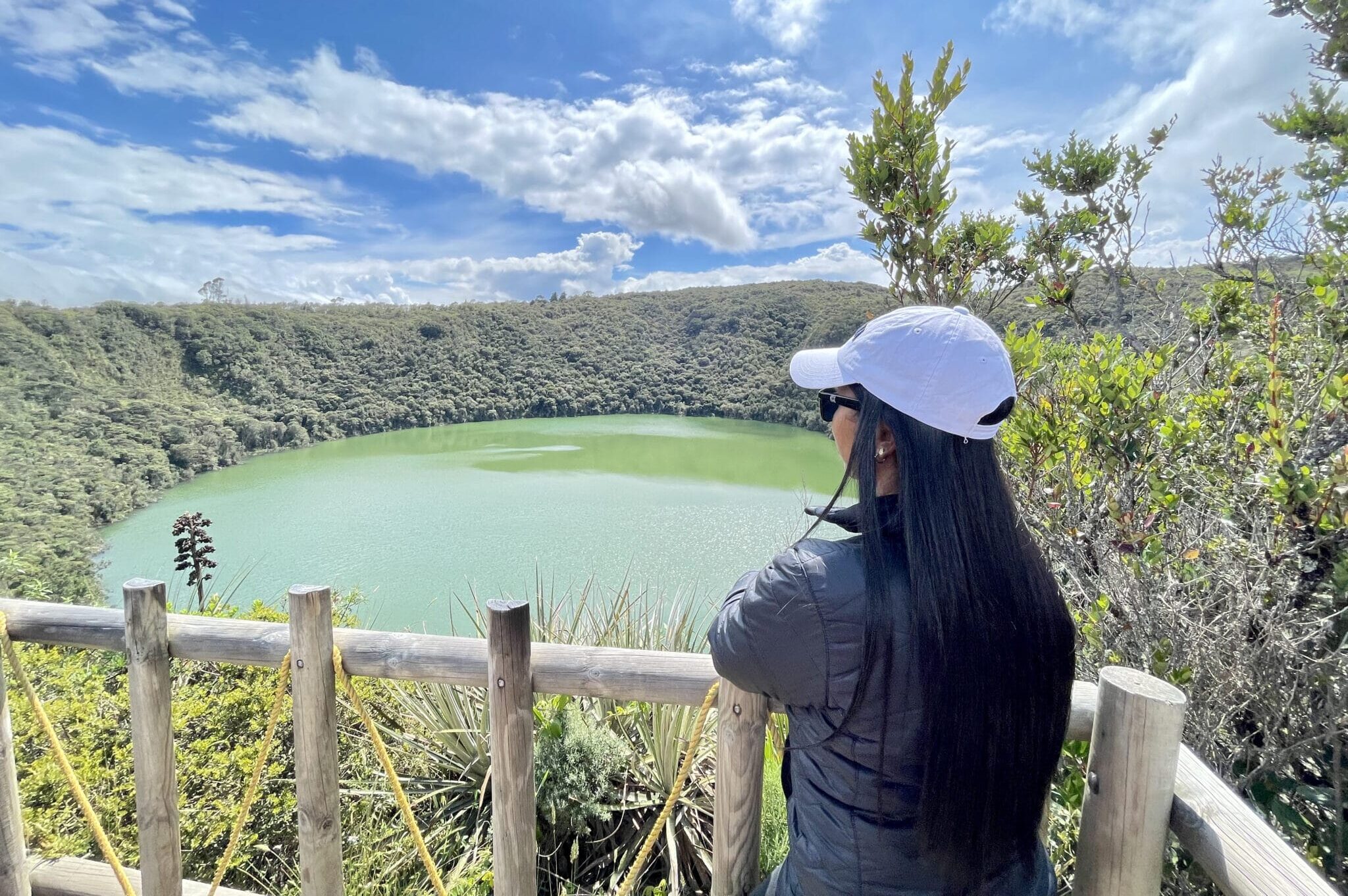 Woman enjoying the Lake Guatavita viewpoint during a Guatavita day trip in Colombia.