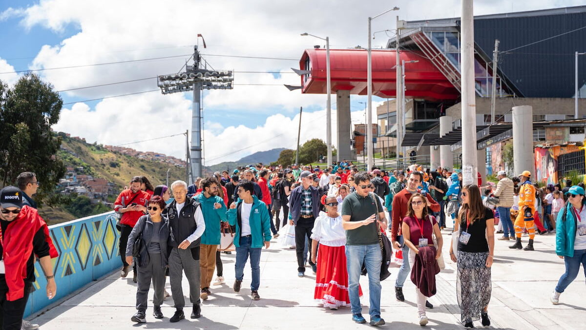 Visitors walking near the TransMiCable station on the El Paraíso Favela Tour in Ciudad Bolívar, Bogotá, Colombia.