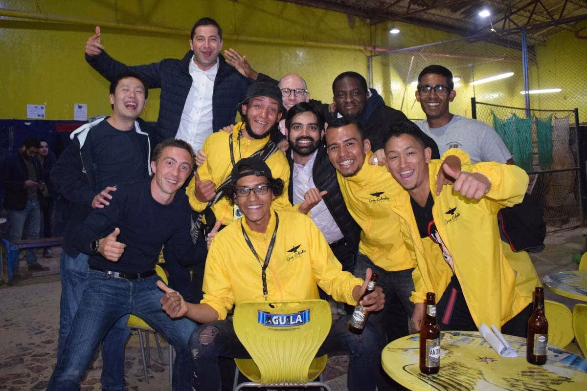 Group posing with beers after a tejo game at La Embajada in Bogotá, Colombia.
