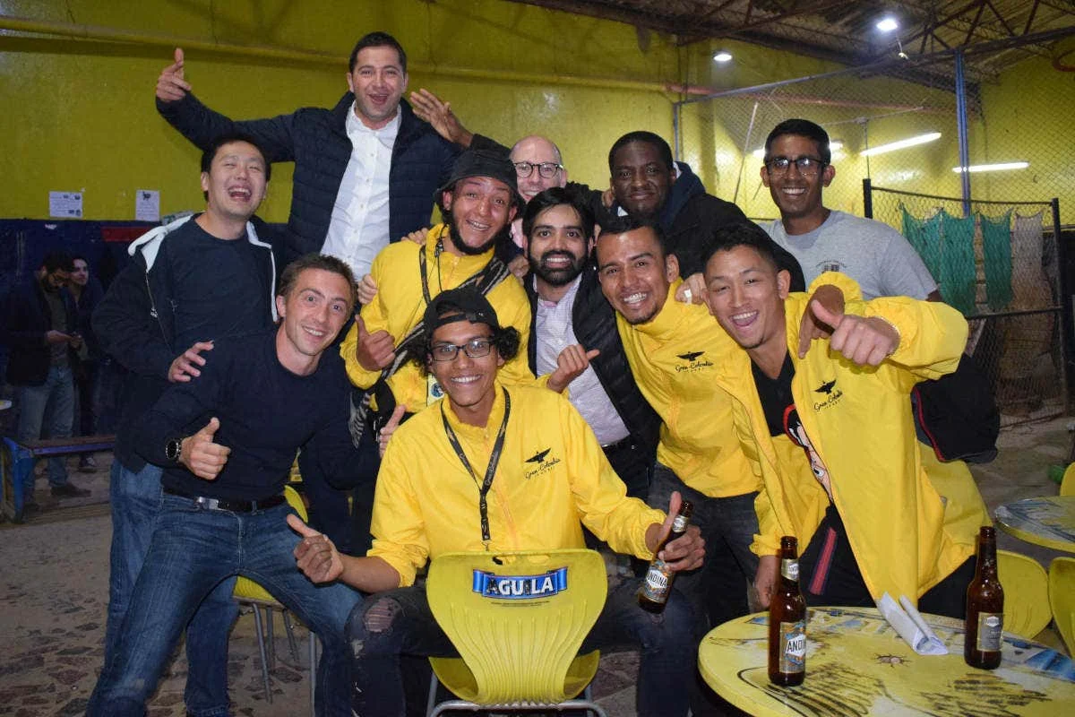 Group posing with beers after a tejo game at La Embajada in Bogotá, Colombia.