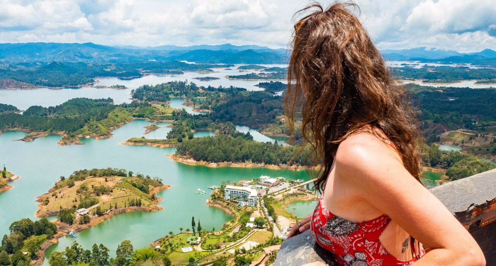 Traveler admiring the reservoir from El Peñol on a Guatape Tour in Guatapé, Colombia