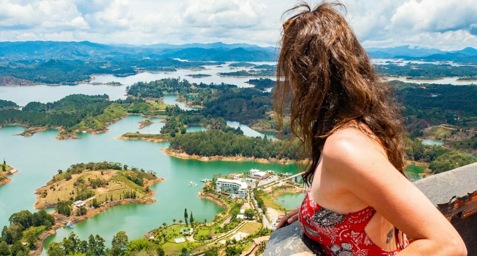 Traveler admiring the reservoir from El Peñol on a Guatape Tour in Guatapé, Colombia