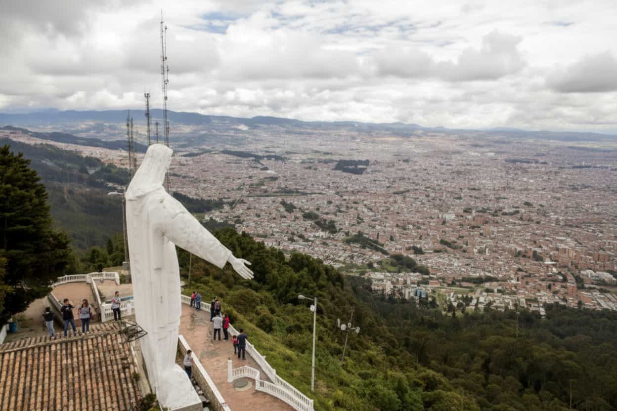 panoramic view of Bogotá city with Guadalupe hilltop statue overlooking the skyline Colombia