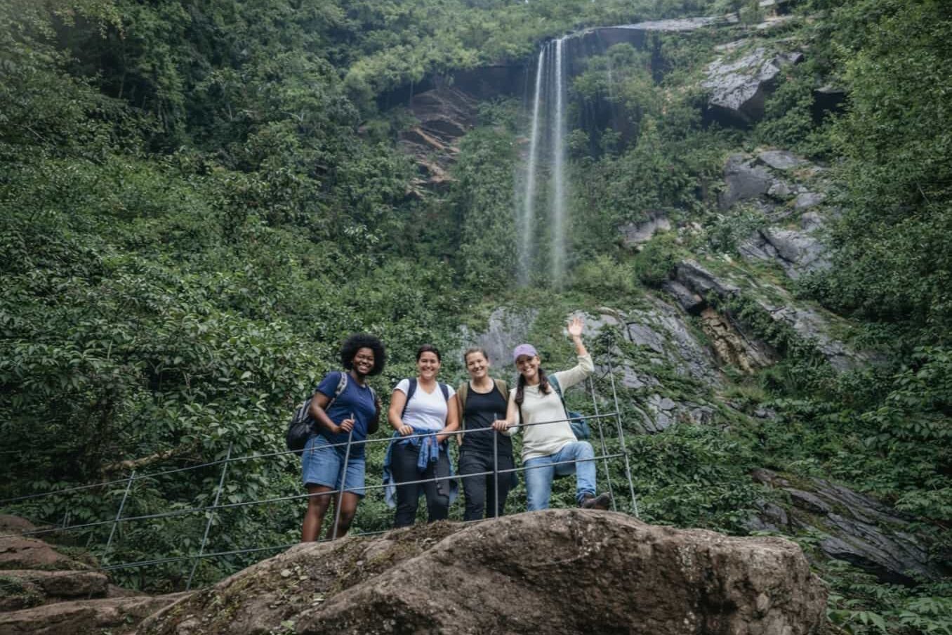 hikers walking along a mountain trail surrounded by Andean forest landscape in Choachí Colombia