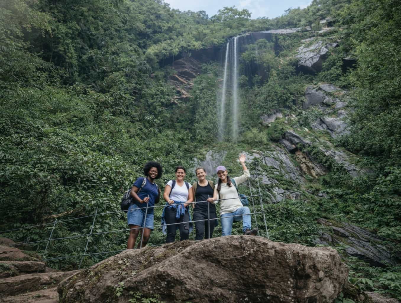 hikers walking along a mountain trail surrounded by Andean forest landscape in Choachí Colombia