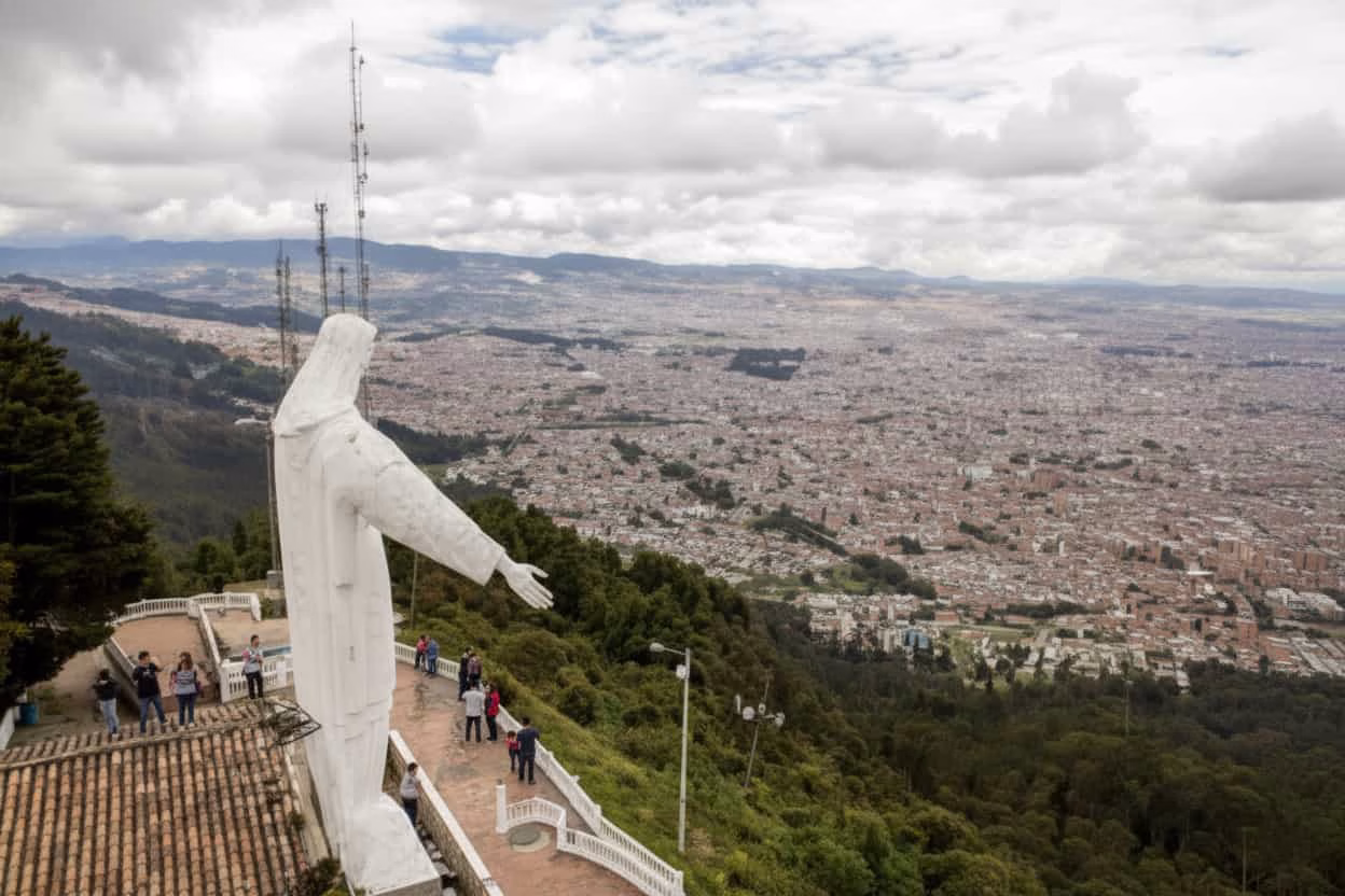 panoramic view of Bogotá city with Guadalupe hilltop statue overlooking the skyline Colombia