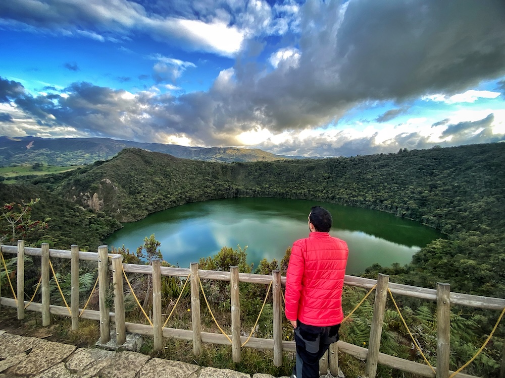 Traveler overlooking Lake Guatavita during a Guatavita day trip in Colombia.