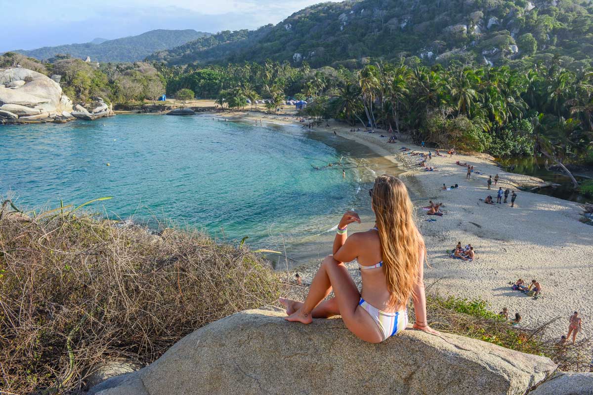 Traveler overlooking a scenic beach and turquoise bay during a Tayrona Park Tour