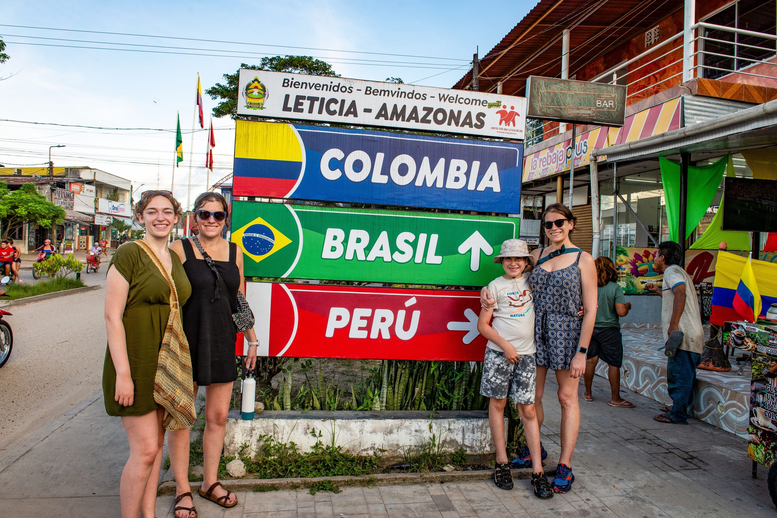 Family visiting the Leticia border landmark between Colombia, Brazil, and Peru on a 5 day Amazon tour.