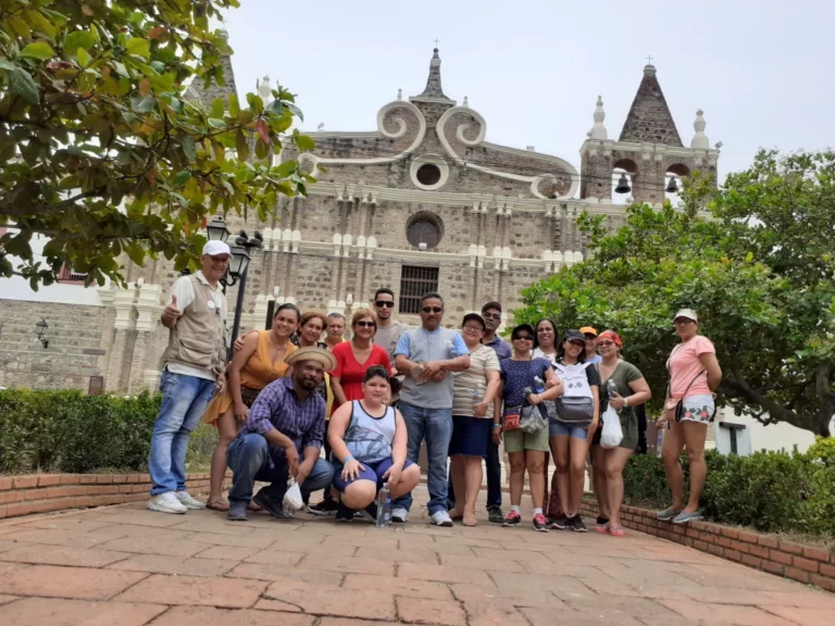 Our group with their guide in front of the stone façade of the cathedral of Santa Fe de Antioquia