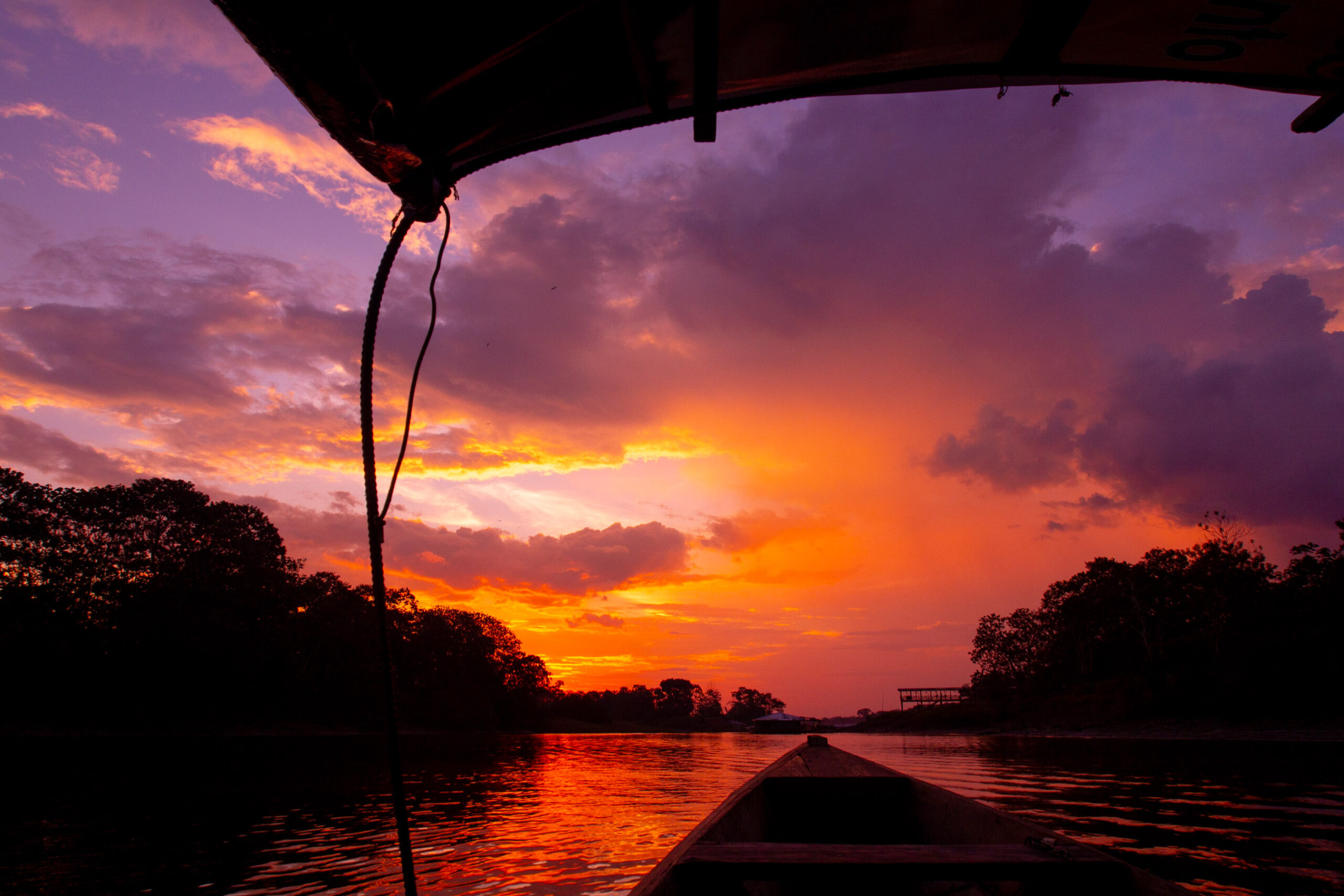 Sunset view from a canoe on the river, a memorable moment during a 5 day Amazon tour.