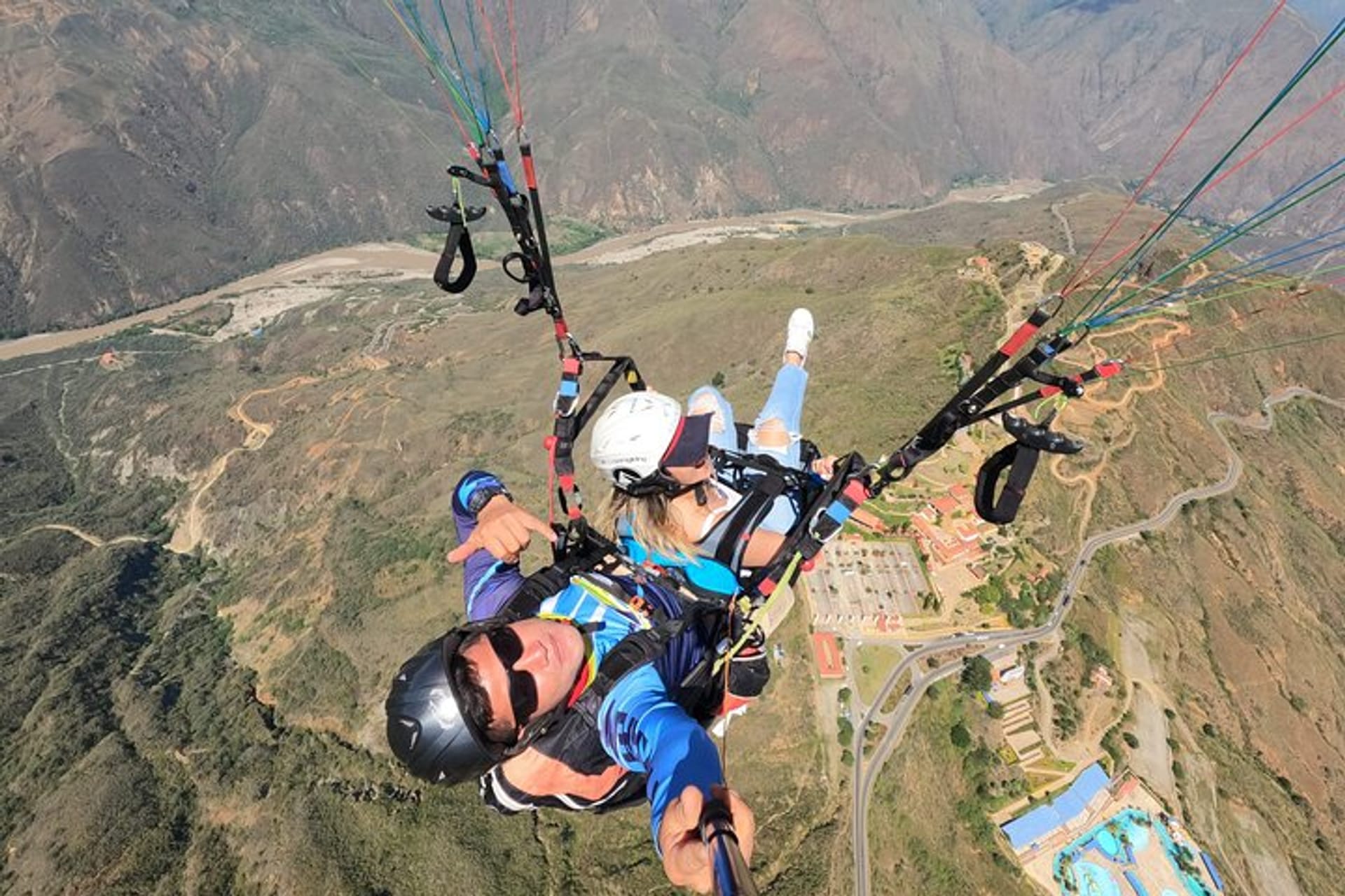 Tandem flight high above the valley with panoramic aerial views during a paragliding Chicamocha Canyon experience