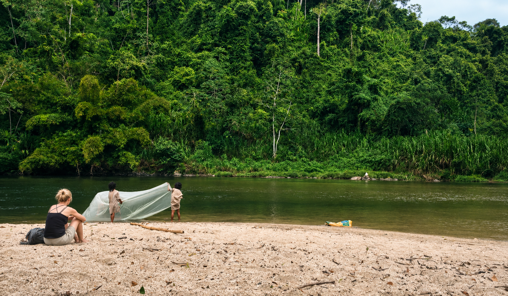Traveler watching Indigenous children fishing by the river during a Tunkeka Culture tour.