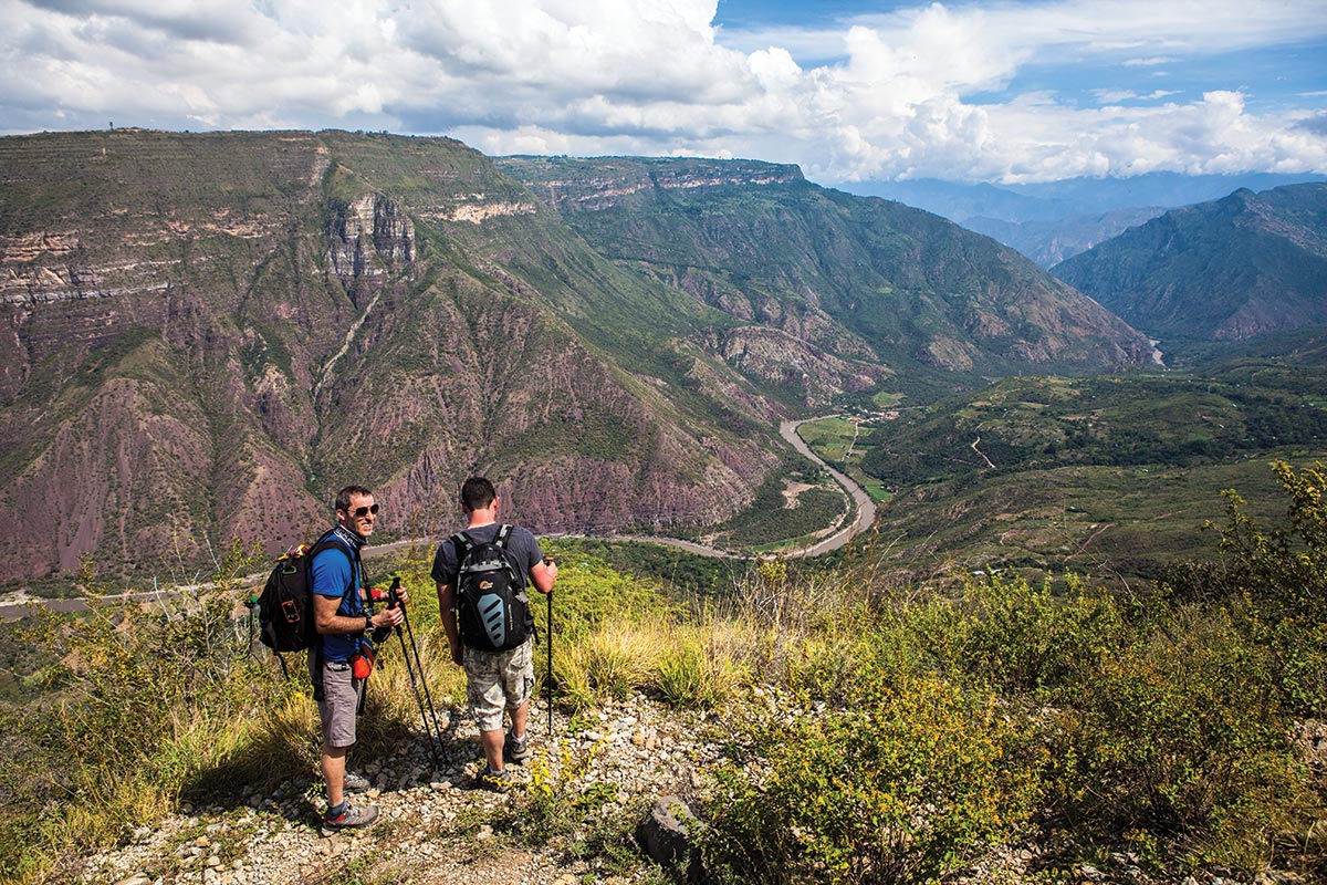 Travelers admiring the breathtaking canyon panorama from a lookout on a Chicamocha National Park Tour.