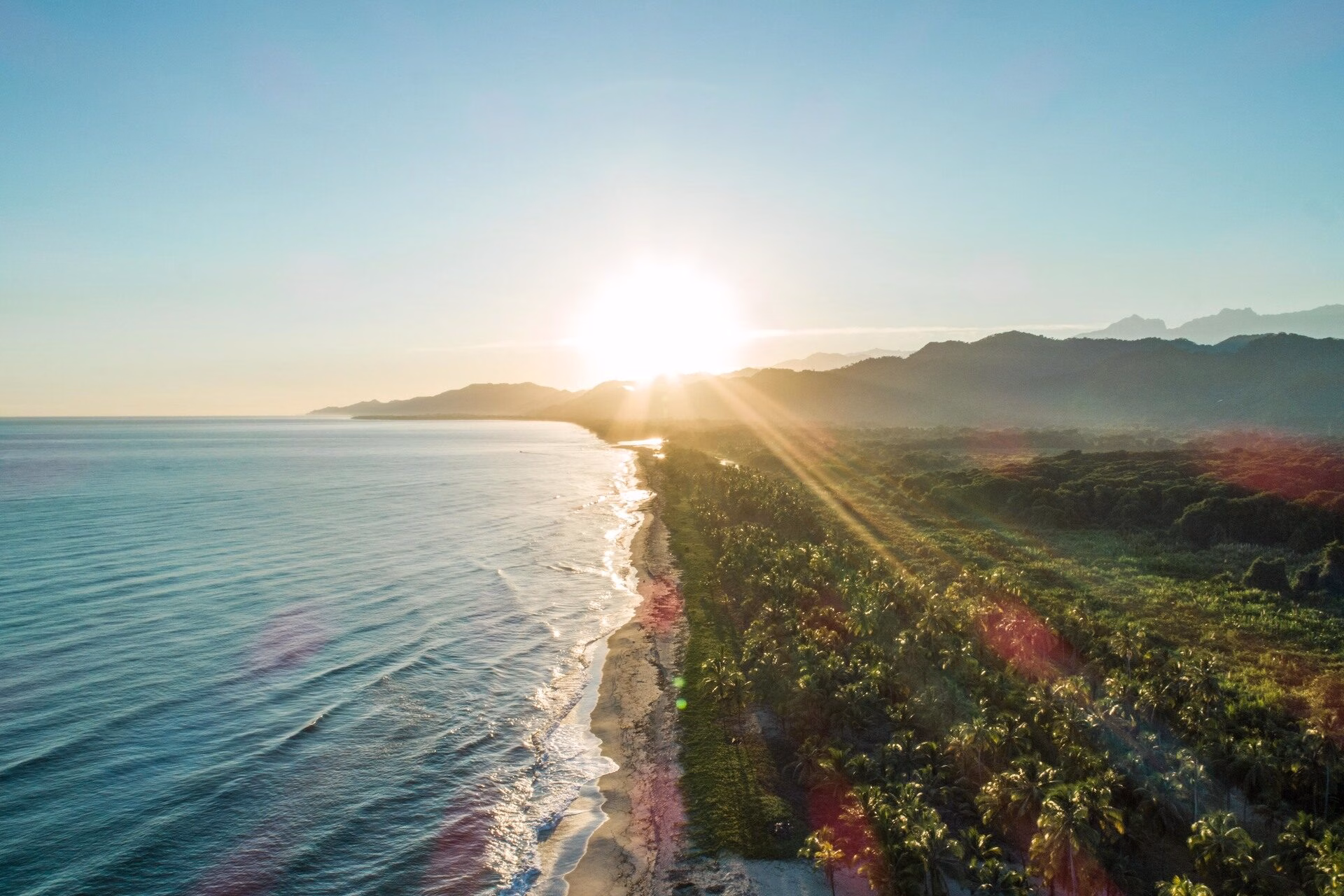 Sunrise aerial view of Tayrona’s coastline and lush tropical landscape on a Tayrona Park Tour.