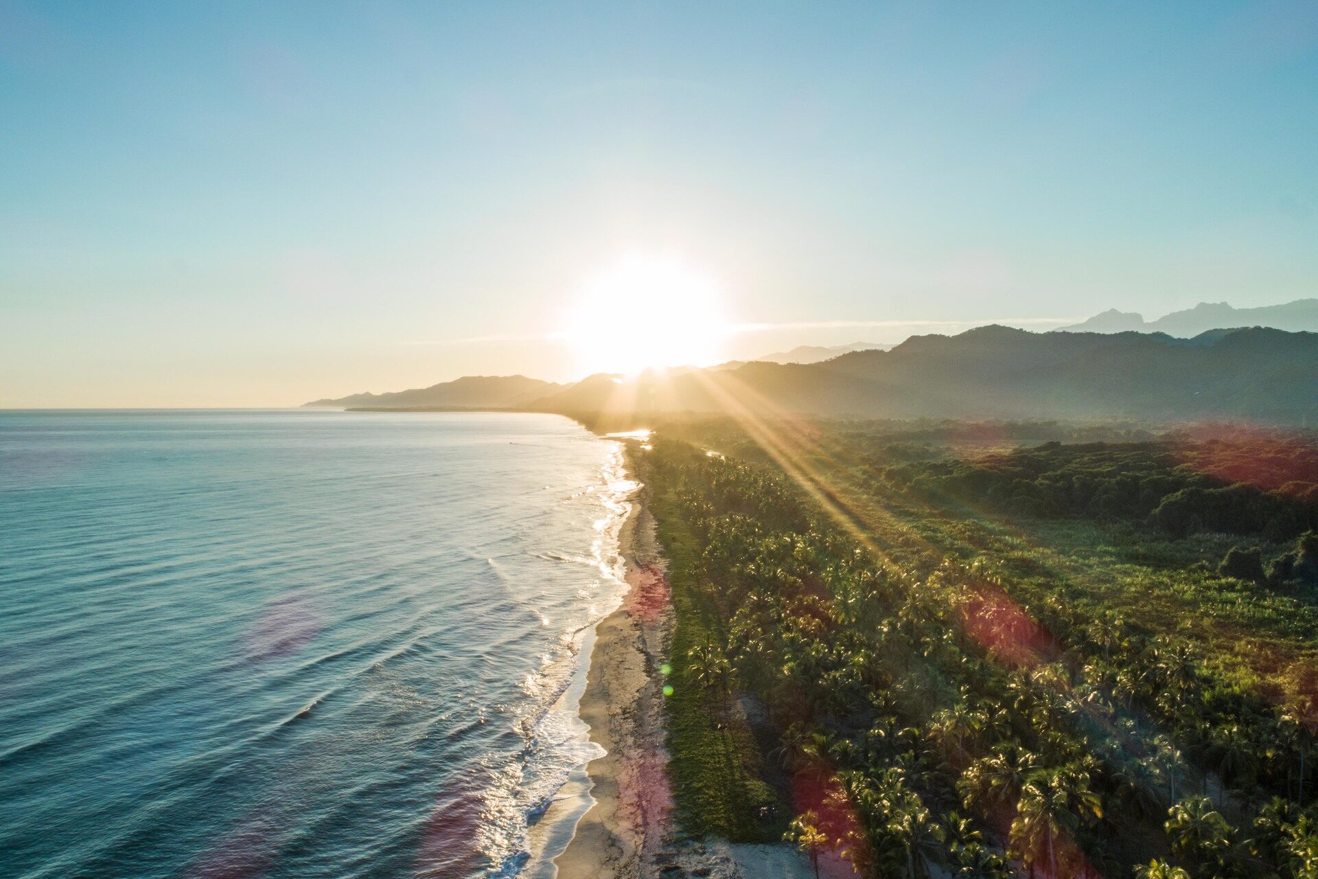 Sunrise aerial view of Tayrona’s coastline and lush tropical landscape on a Tayrona Park Tour.