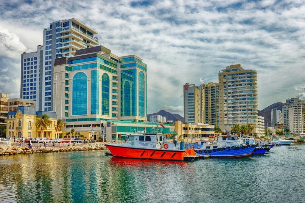 Boats docked along the marina with Santa Marta’s waterfront skyline in view during a Santa Marta City Tour.
