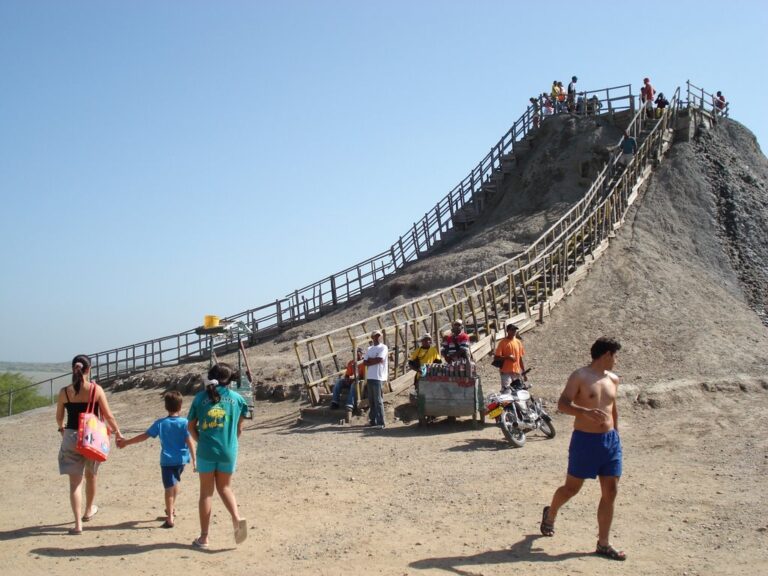 Visitors at the foot of the El Totumo mud volcano, with the wooden staircase up its side