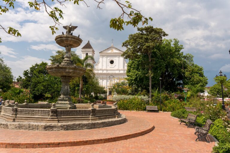 The stone fountain and the white cathedral on the main square of Santa Fe de Antioquia