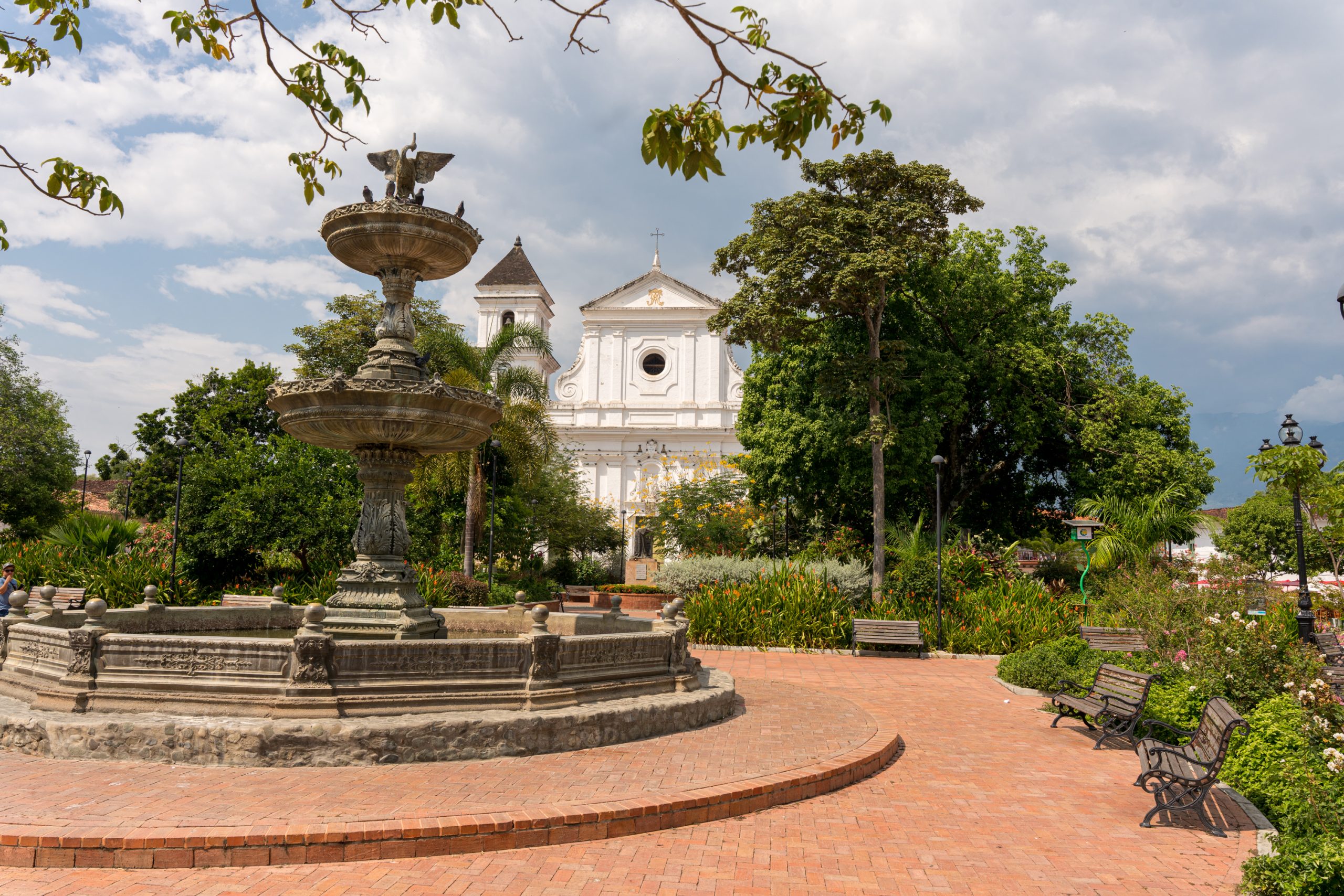 Historic fountain and white church in the main square on a Tour Santa Fe de Antioquia, Colombia