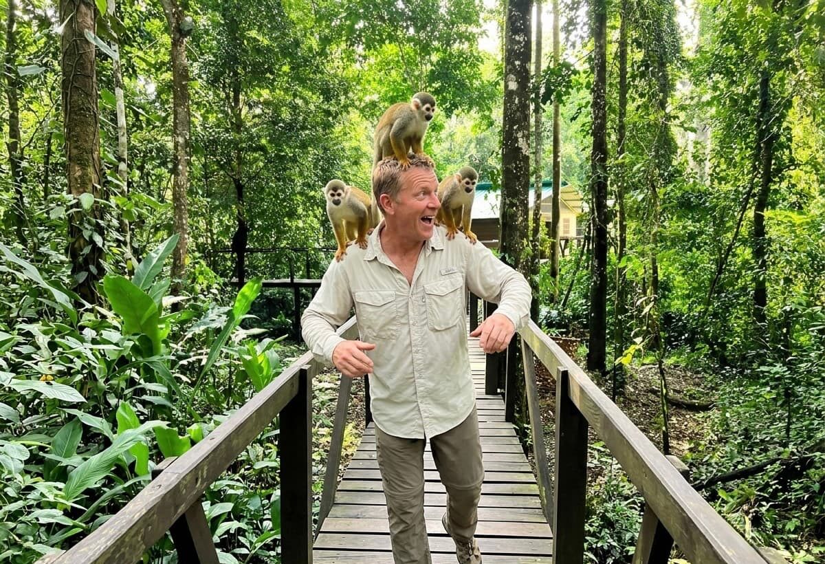 A guide on a raised wooden walkway through Amazon rainforest near Leticia