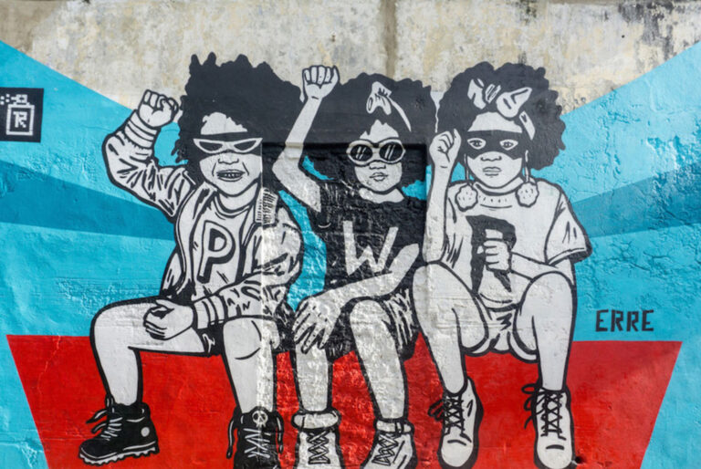 Mural of three children with raised fists on a wall in Getsemaní, Cartagena