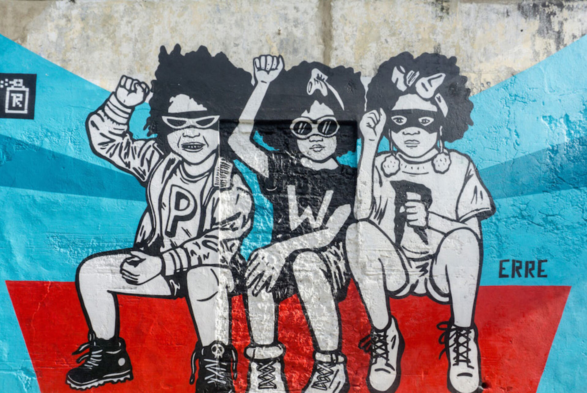 Black and white mural of three children seen on a Graffiti Tour in Cartagena, Colombia