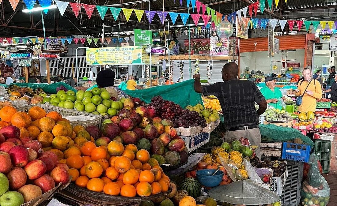 Fresh tropical fruit stands inside a traditional local market visited on a Food Tour Cali.